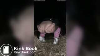 Girl pooping at night in the field